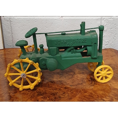 112 - A cast Iron John Deere Tractor. 30 x 18 cm approx.