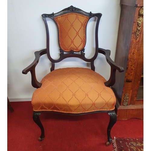 433 - A pair of late 19th Century Mahogany Armchairs with carved cabriole front supports and brass castors... 