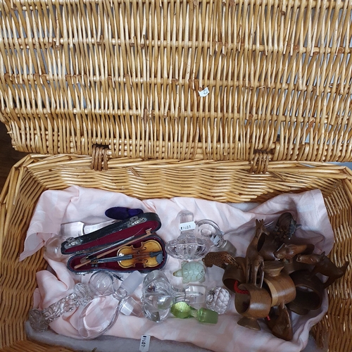 563 - A quantity of Decanter lids, miniature violin, treen etc, all in a  wicker basket.