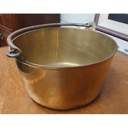 555 - A good heavy Brass Pot with a Cast Iron handle.
D 26 cm approx.