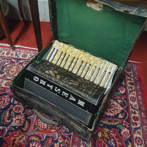 106 - A vintage cased Maestro Accordion along with sheet music.