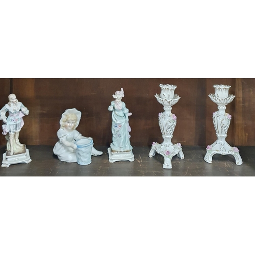 88 - A quantity of Porcelain and other figures on three shelves.