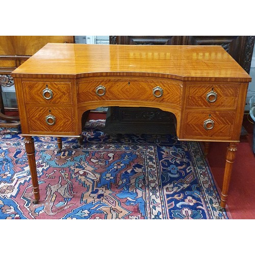 621 - An Edwardian Satinwood concave Writing Desk of superb quality, with Brass ring handles on turned squ... 