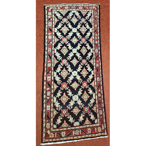 382 - A deep Blue ground woven Persian village Rug with a bespoke all over design. 205 x 86 cm approx.