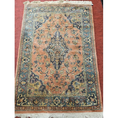 553 - A rust ground Rug with multi borders and unique central medallion design. 186 x 122 cm approx.