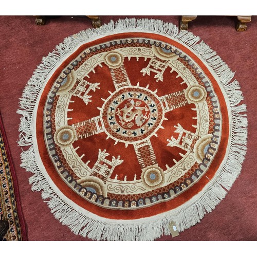 644 - A Red ground circular Rug with tasseled edge.
D 153 cm approx.