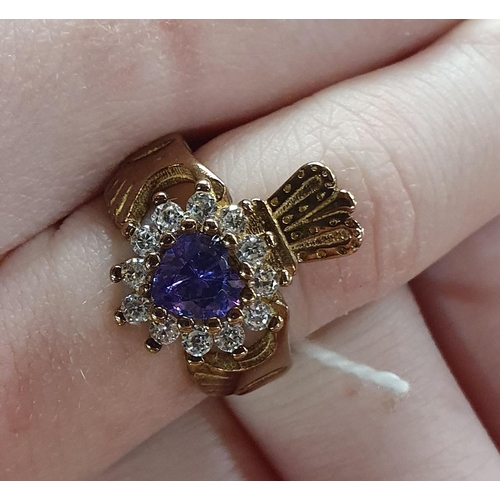 309 - A heavy 9ct Gold Claddagh Ring set with a large Amethyst, size H 1/2.