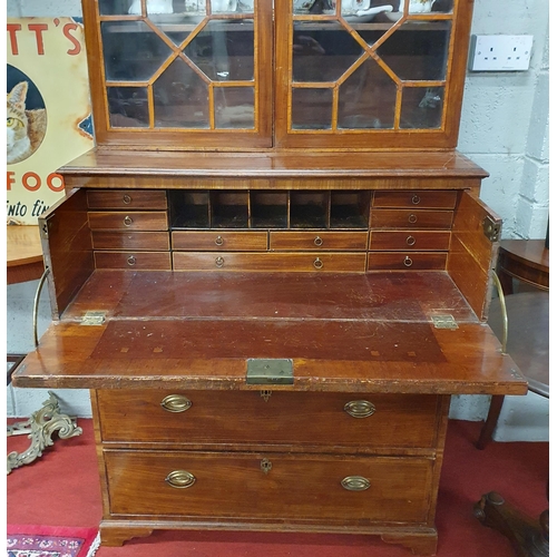 123 - An early 19th Century Regency Mahogany Seretaire Bookcase of neat proportions with brass ring handle... 