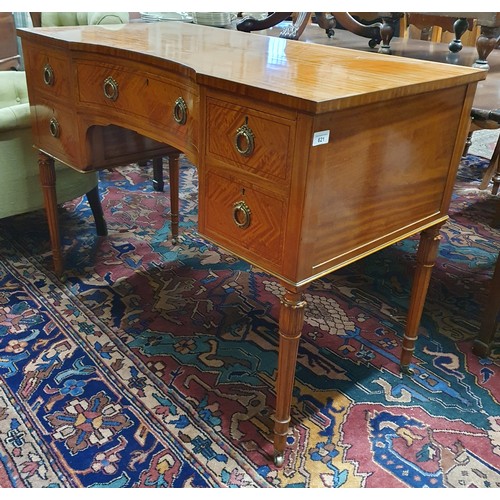 621 - An Edwardian Satinwood concave Writing Desk of superb quality, with Brass ring handles on turned squ... 