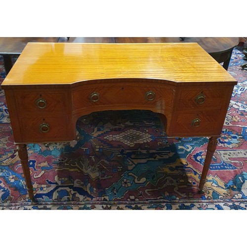 621 - An Edwardian Satinwood concave Writing Desk of superb quality, with Brass ring handles on turned squ... 