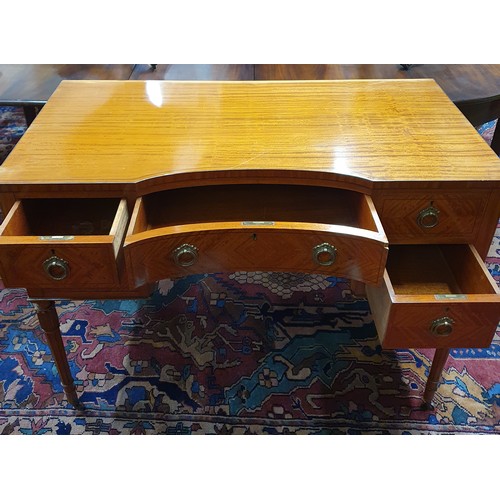 621 - An Edwardian Satinwood concave Writing Desk of superb quality, with Brass ring handles on turned squ... 