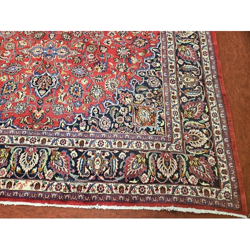 381 - A large Red ground fine handwoven Persian Mashed Carpet with a lozenge medallion design. 390 x 300 c... 