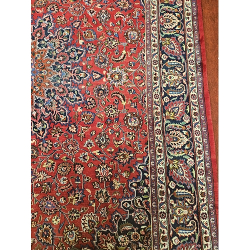 381 - A large Red ground fine handwoven Persian Mashed Carpet with a lozenge medallion design. 390 x 300 c... 