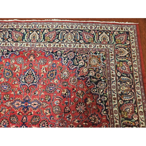 381 - A large Red ground fine handwoven Persian Mashed Carpet with a lozenge medallion design. 390 x 300 c... 