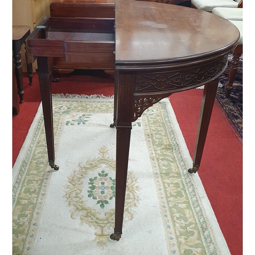 404 - A late 19th Century Mahogany half moon foldover Card Table with fretwork frieze and details on squar... 