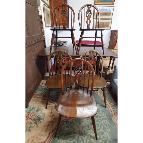 459 - An Ercol Dining Table and set of five Chairs.