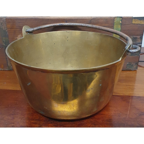 555 - A good heavy Brass Pot with a Cast Iron handle.
D 26 cm approx.