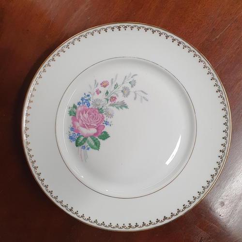 589 - A very large quantity of PL Limoges Dinnerwares with gilt banding on a floral theme.