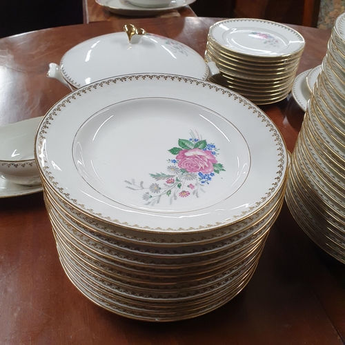 589 - A very large quantity of PL Limoges Dinnerwares with gilt banding on a floral theme.