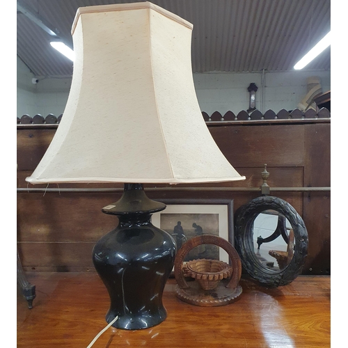 677 - A Table Lamp with Shade. H 45 cm approx.
Along with a circular Mirror, a Wooden fruit basket and a p... 