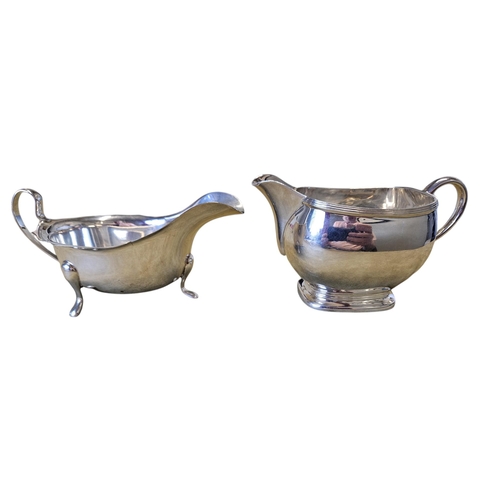 307 - A London Silver milk Jug along with a Sheffield Silver sauce Boat, 265 grams approx. TB 7 cm approx.
