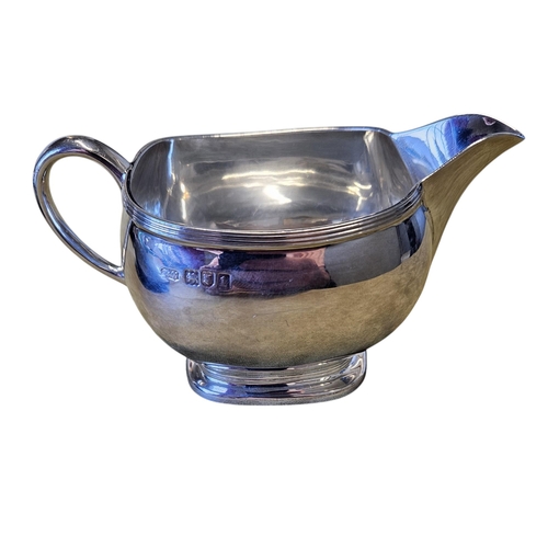 307 - A London Silver milk Jug along with a Sheffield Silver sauce Boat, 265 grams approx. TB 7 cm approx.