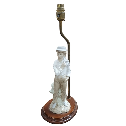 144 - A Coalport centre dish in the Imari pattern, along with a Spanish Figure table lamp.
TB 42 cm approx... 