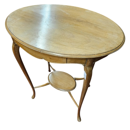 451 - A very neat Edwardian Blond Mahogany oval Lamp Table with single frieze drawer.
H 69 x D 55 cm appro... 