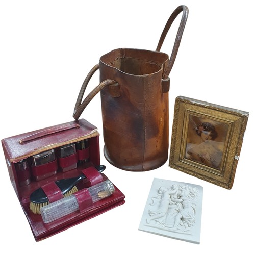 124 - A 19th Century Leather fire Bucket along with a cased vanity set, a parian ware style plaque and cry... 