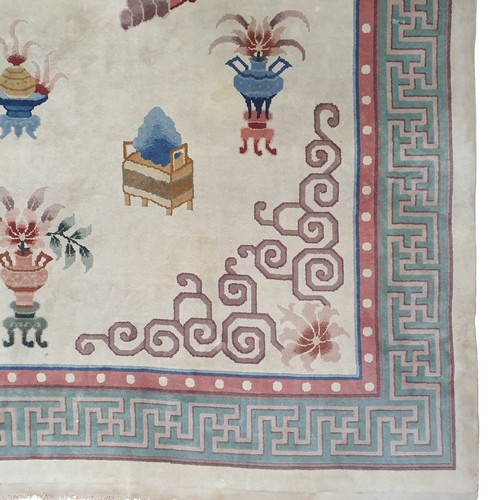 159 - A cream ground Oriental Carpet with Greek key border design. 244 x 345 cm approx.