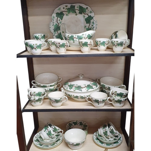 73 - A good quantity of Wedgwood Napoleon Ivy pattern Dinnerwares on three shelves.
