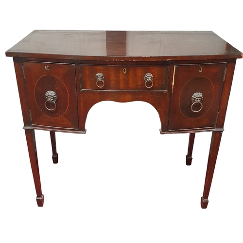 84 - A 20th Century Mahogany bow fronted Sideboard of miniature size with lions head handles and square t... 
