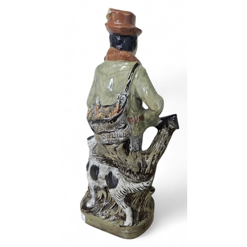 46 - An Italian hand painted Decanter Figure of a huntsman and hound. H 27 cm approx.