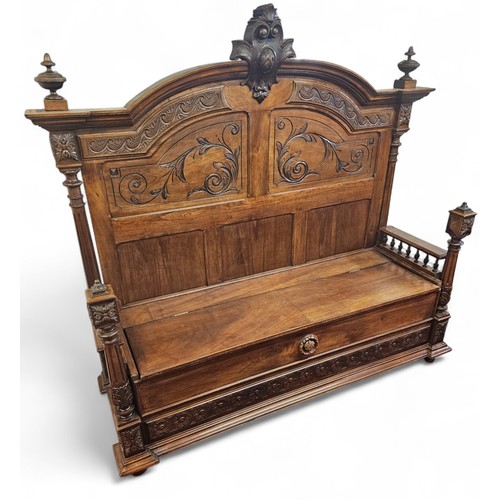 34 - A Large Walnut Hall Bench with lift up seat and highly carved outline. 166 x D 56 x H 155 cm approx.