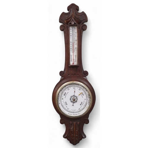 11 - An early 20th Century Aneroid Barometer. L65 cm approx.
