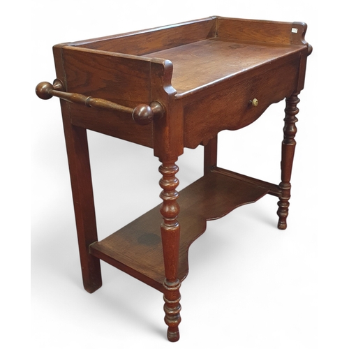 48 - A 19th Century Oak Washstand with hanging towel lifting supports on turned supports. 86 x 39 x H 77 ... 