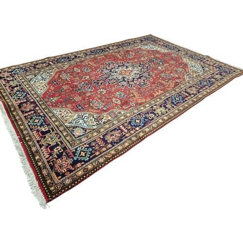 5 - A rich multi coloured hand woven Persian Tabriz Carpet with lozenge medallion design.
L 303 x 193 cm... 