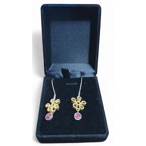 382A - A pair of Silver Gold plated and natural Ruby Earrings.