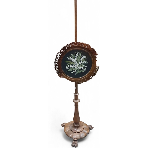 453 - An early 19th Century Rosewood Pole Screen with tapestry centre. Possibly Irish. H 133 cm approx.