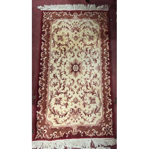 835 - A pair of red and cream ground Rugs.
88 x 171 cm approx.