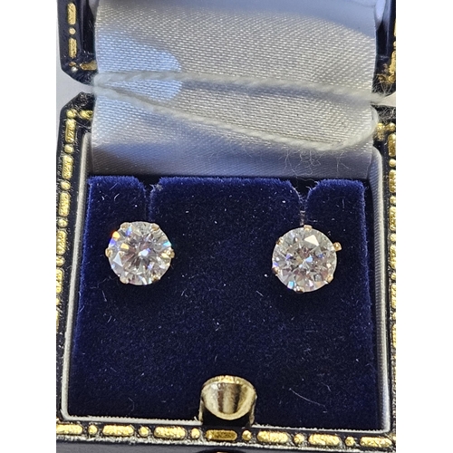 300 - A pair of 9ct Gold and CZ Earrings.