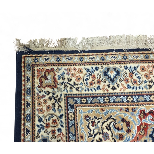 6 - A blue and cream ground Carpet with multi borders and central medallion design. 280 x 190 cm approx.