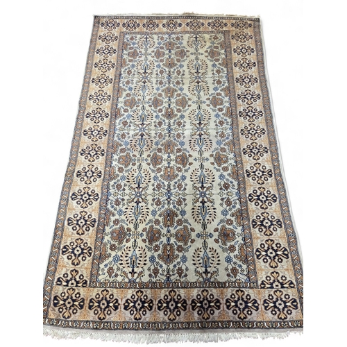 25 - A beige ground Carpet with multi borders and repeating central medallion design. 257 x 157 cm approx... 