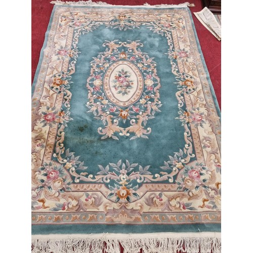 423 - A green ground Oriental Carpet with floral design 290 x 190 cm approx.
