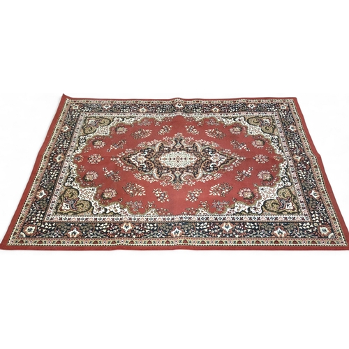 427 - A large European red ground Rug with central floral motif floral spandrels and multiple floral borde... 