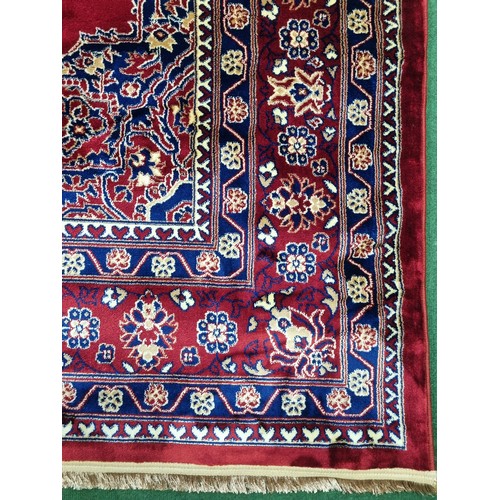 435 - A red ground Turkish Soft Full Pile Carpet with central medallion design surrounded by borders and b... 
