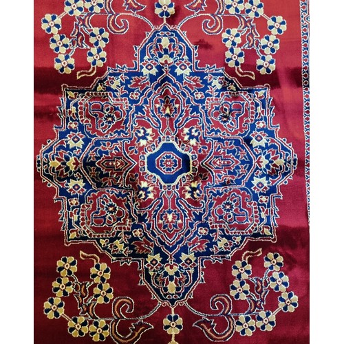 435 - A red ground Turkish Soft Full Pile Carpet with central medallion design surrounded by borders and b... 