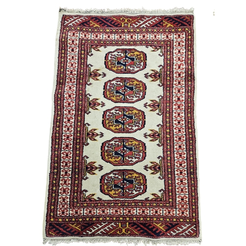 449 - A cream and red ground Rug. 103 x 66 cm approx.