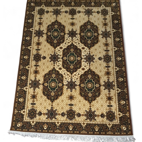 452 - A Gold ground Rug with repeating central medallion design and multi borders. 141 x 210 cm approx.