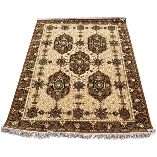 452 - A Gold ground Rug with repeating central medallion design and multi borders. 141 x 210 cm approx.